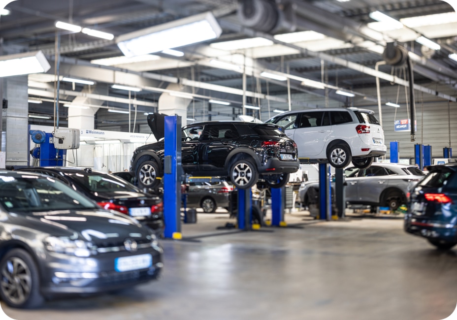 used vehicle reconditioning center with several cars in preparation